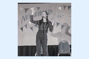 Poet Kate Wilson performing on a festival stage